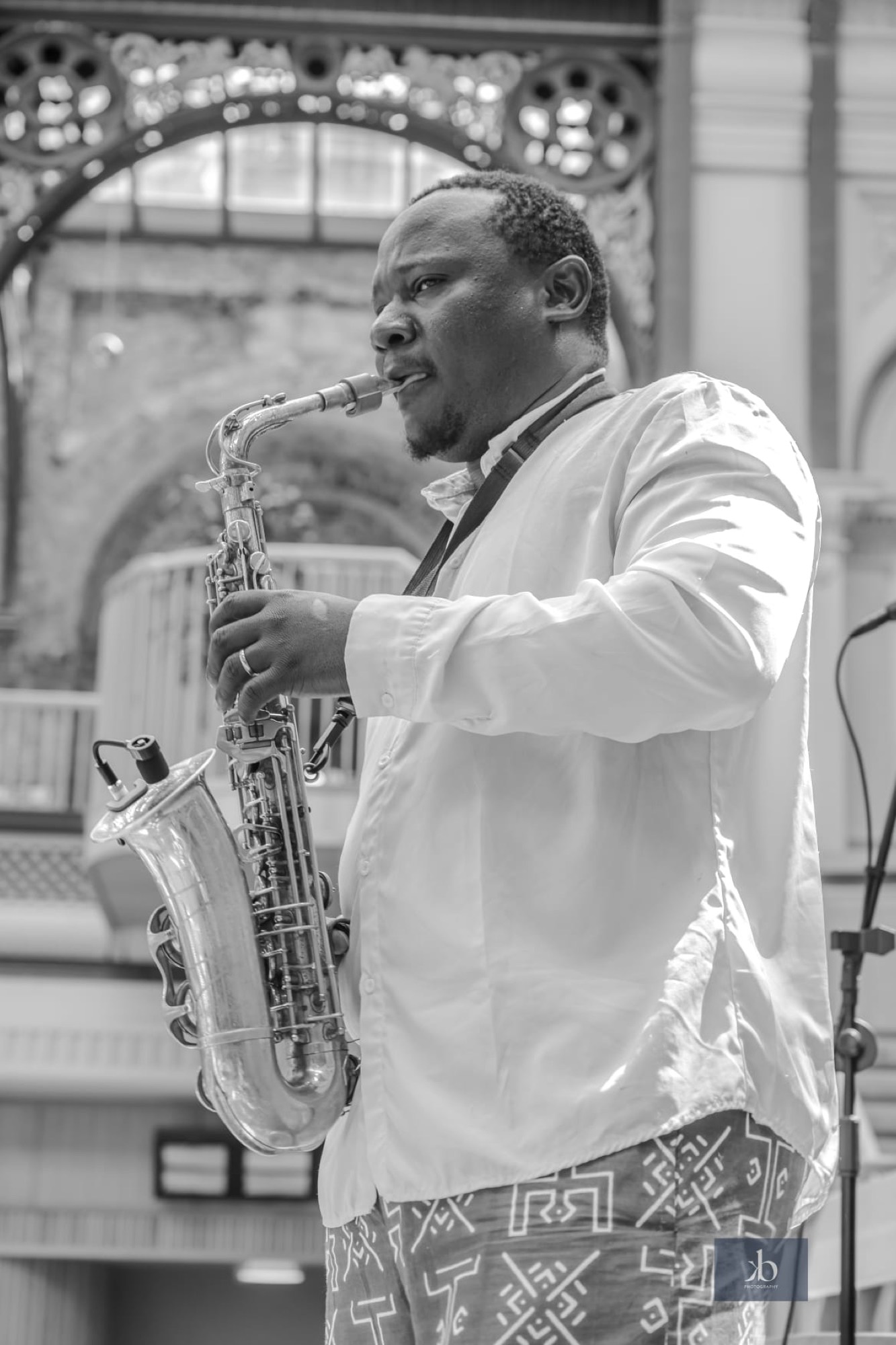 Olamide Sax mid-performance on saxophone.