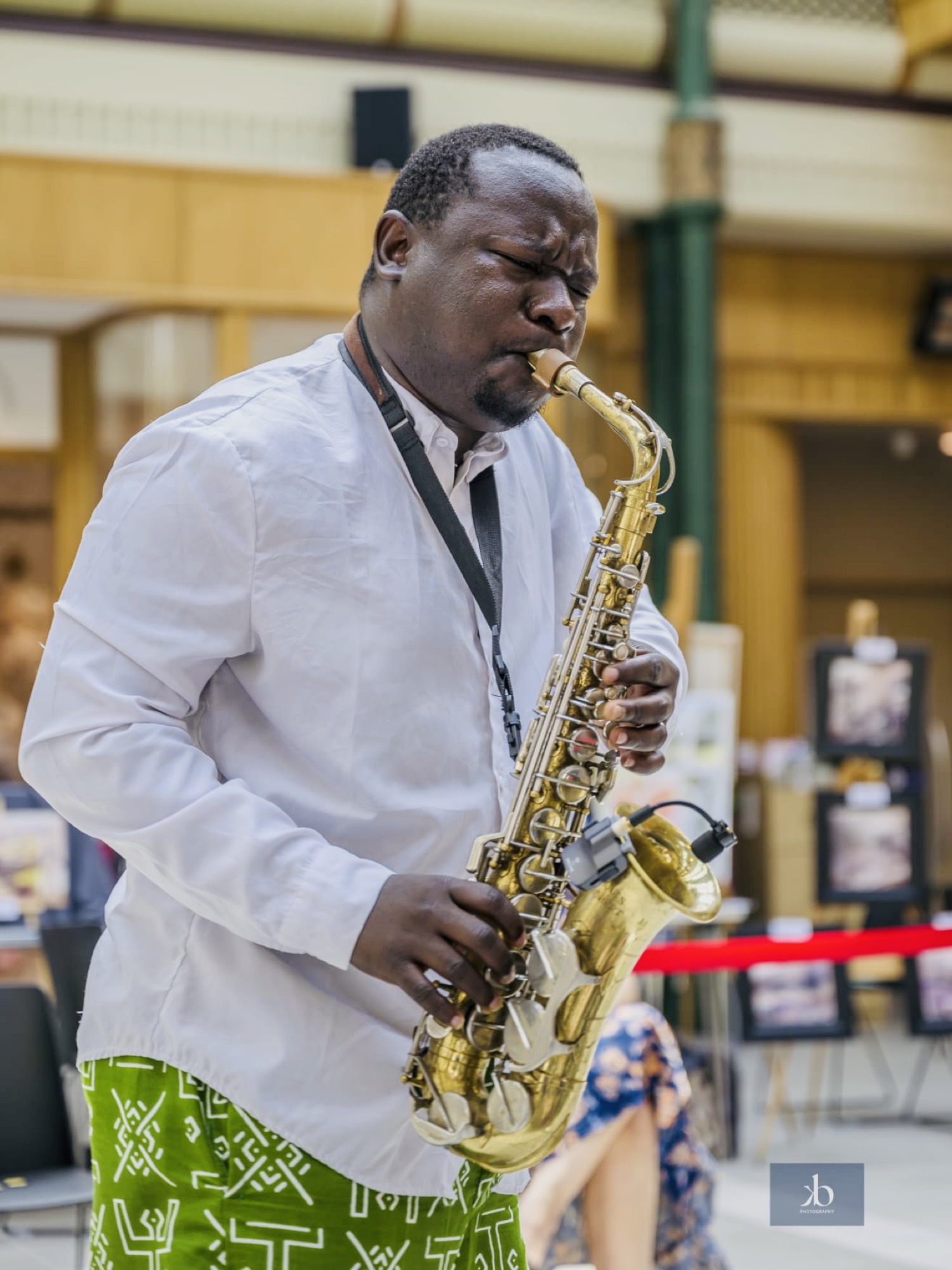 Playing saxophone in a bustling market.