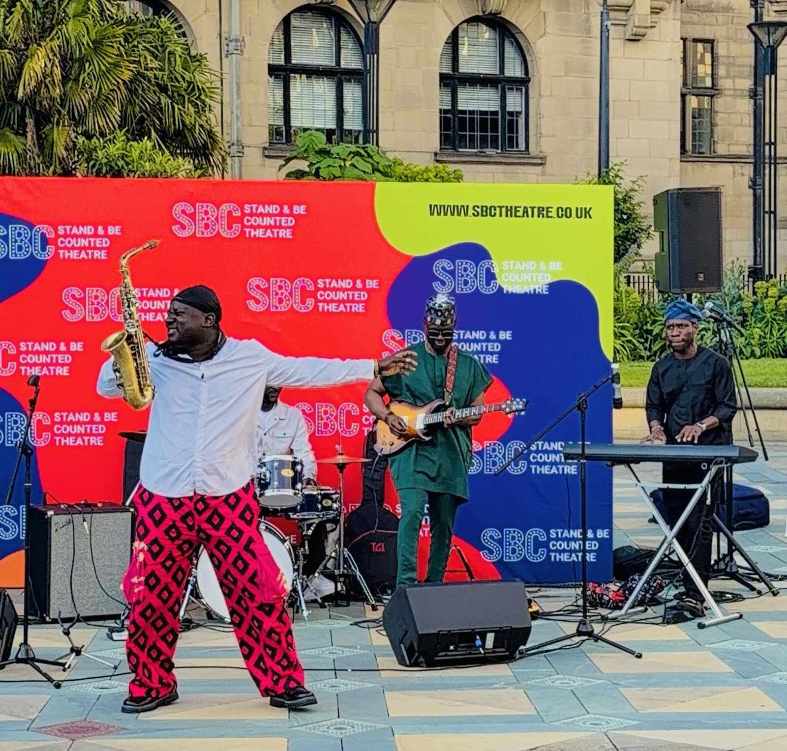 Olamide Sax in dynamic motion mid-set.