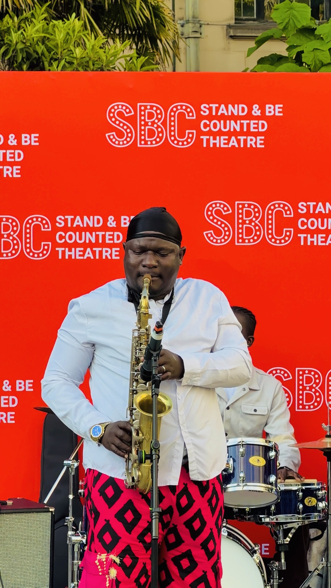 Olamide Sax on the Stand & Be Counted procession stage.